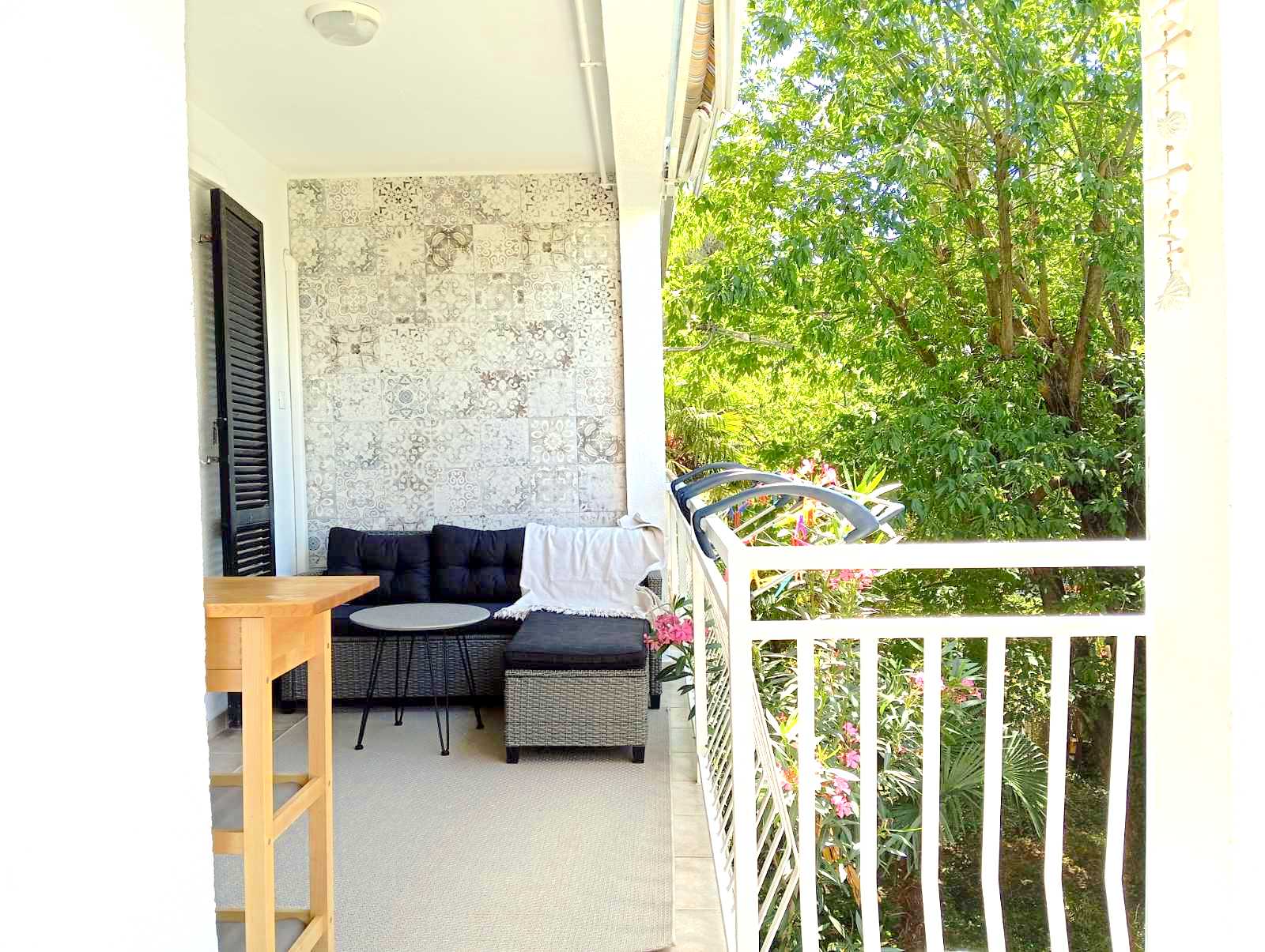 Covered balcony lounge area with garden views